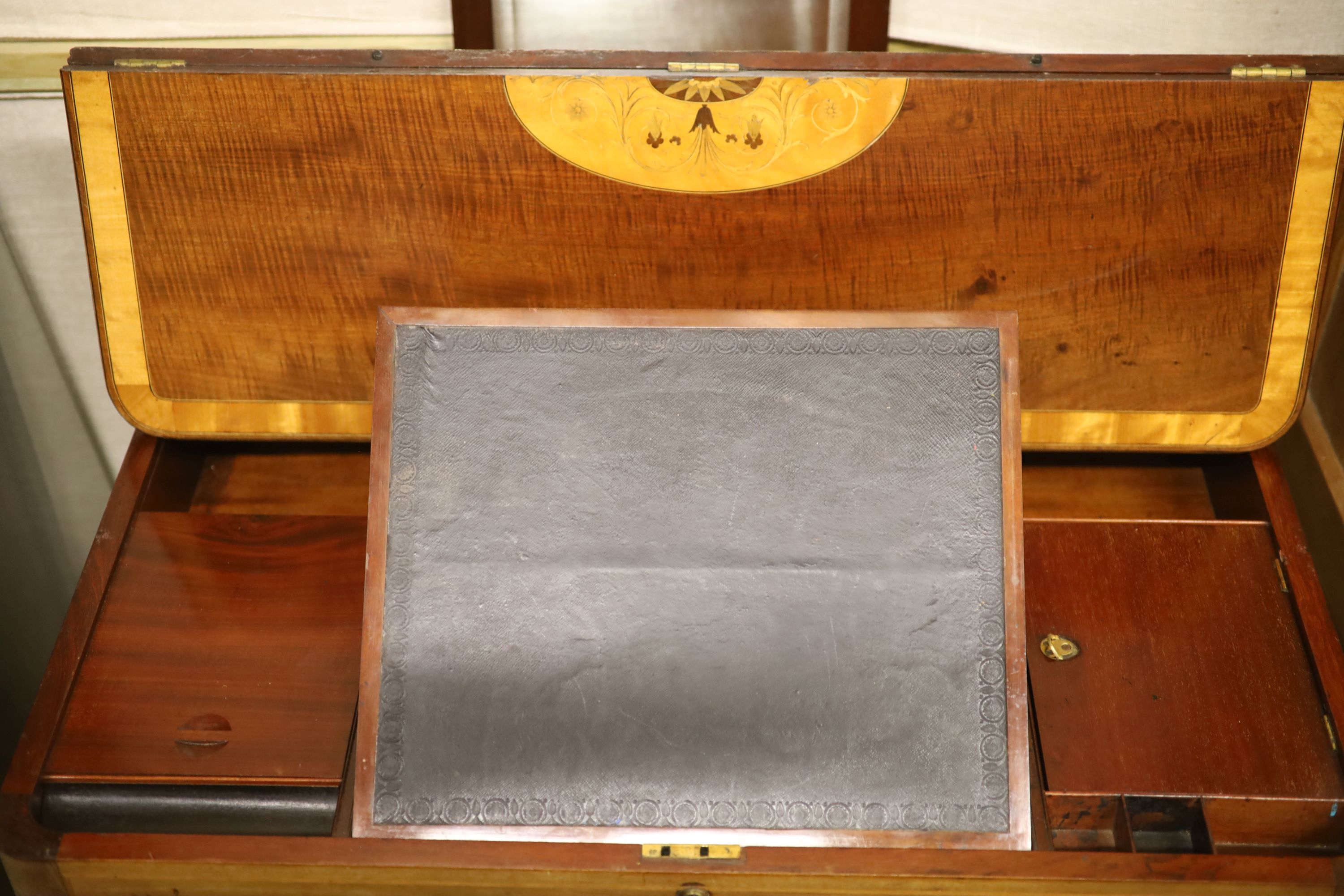 A Regency satin banded inlaid mahogany hinged top writing table, width 93cm depth 61cm height 75cm